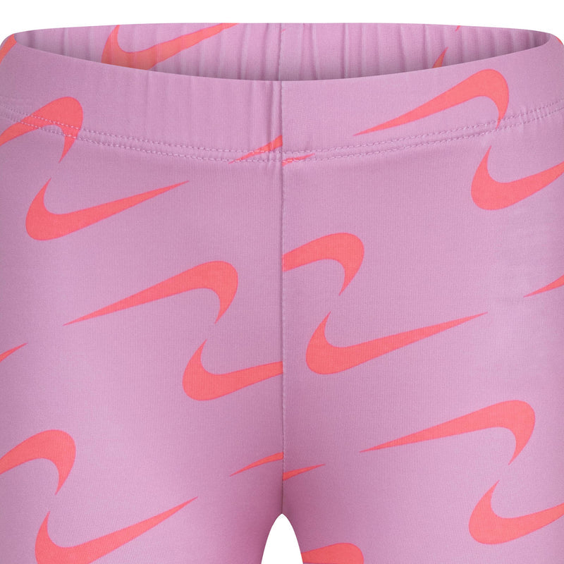 Pink patterned leggings with Nike swoosh; elastic waistband close-up