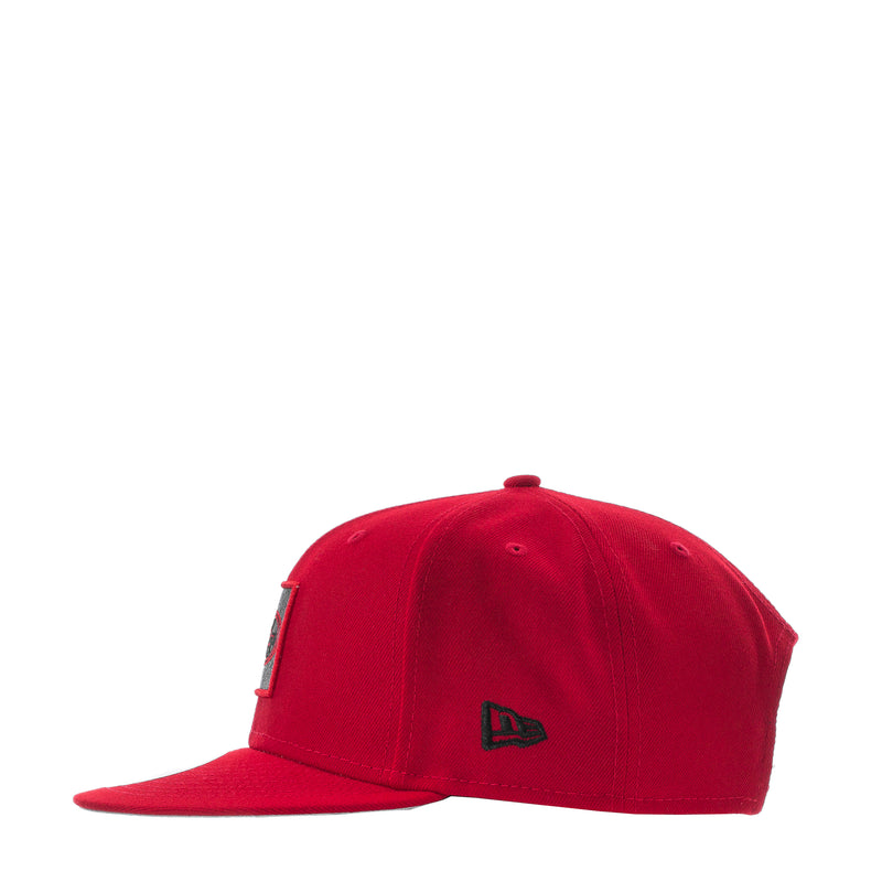 Red baseball cap with dark side emblem and curved brim