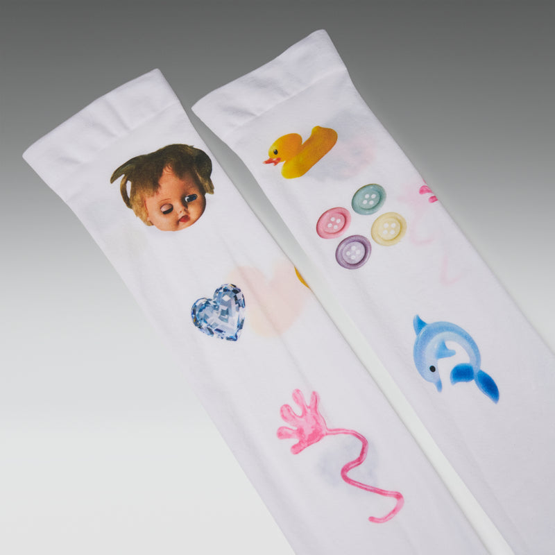 Two white baby socks with colorful designs on a gray background