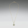 Gold necklace with a star-shaped pendant on a gradient gray background