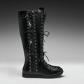 A single black leather knee-high lace-up boot with silver metal eyelets and decorative skull-and-crossbones laces, shown in profile against a dark gray studio background.