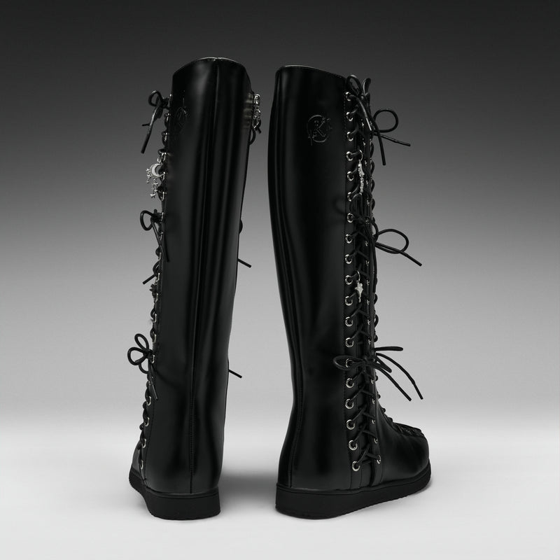 A pair of black knee-high lace-up boots shown from the back on a dark-to-light gray gradient studio background.