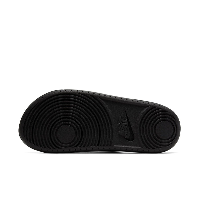 Women's black slide sandal outsole with circular tread and Nike logo