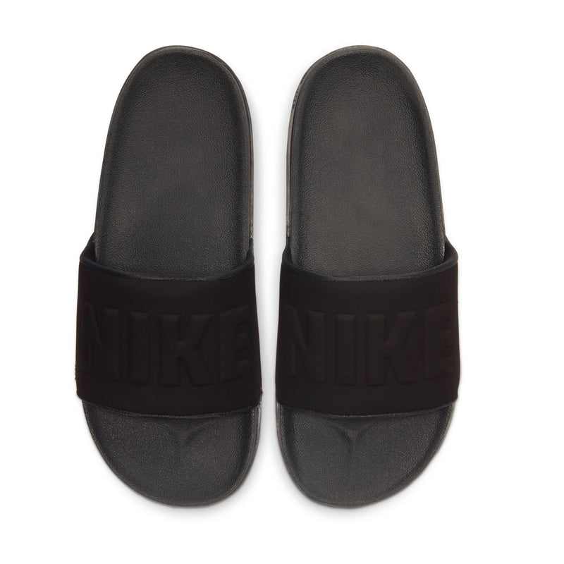 Men's slide sandals, close-up of black footbeds with raised strap logo