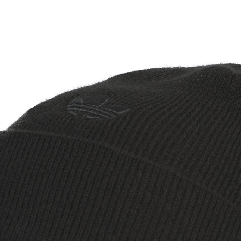 Black knit beanie close-up of three-bar logo on cuff