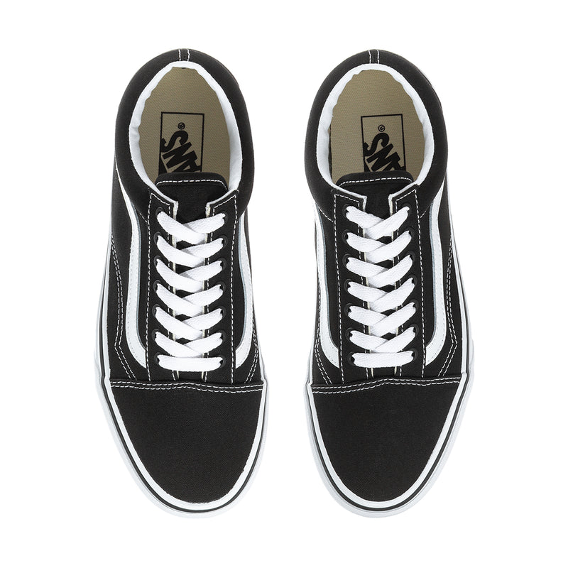Men's black sneaker interior view with white laces and Vans logo on tongue lining