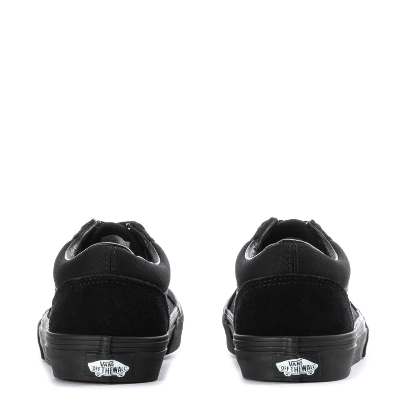 Youth black skate sneakers heel view with Vans Off the Wall patch