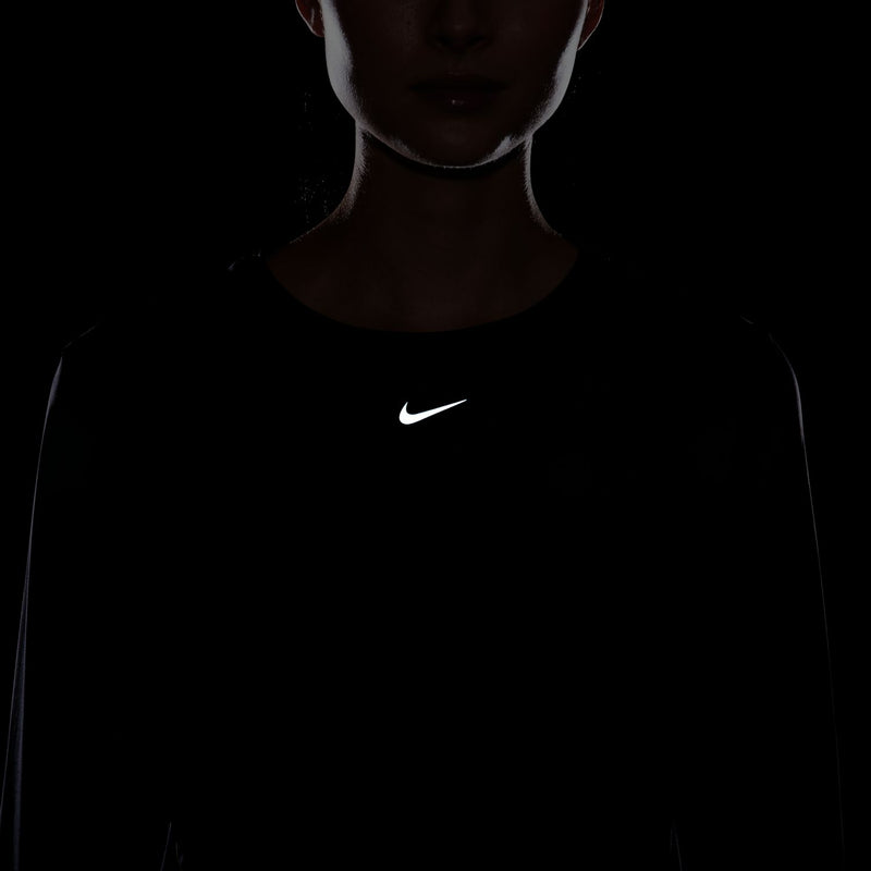 Women's black long-sleeve Dri-FIT top with centered Nike swoosh
