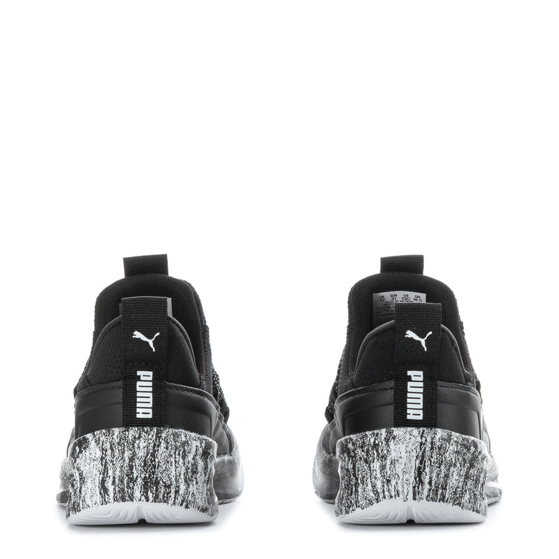 Kids black PUMA sneakers from back view, heel pull tab, speckled heel panel