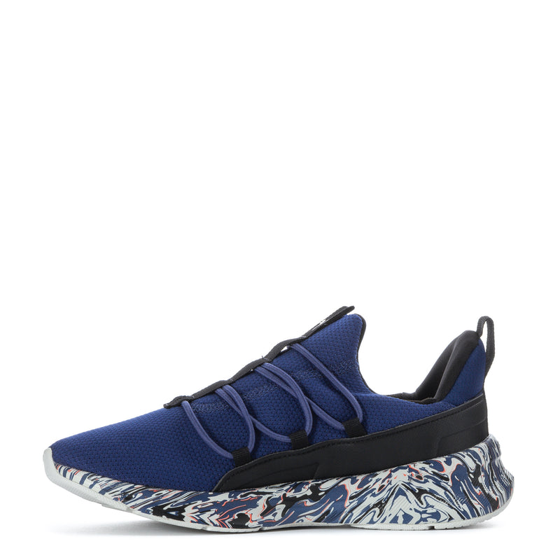 Blue youth knit sneaker with black midfoot strap and patterned outsole, red Puma logo