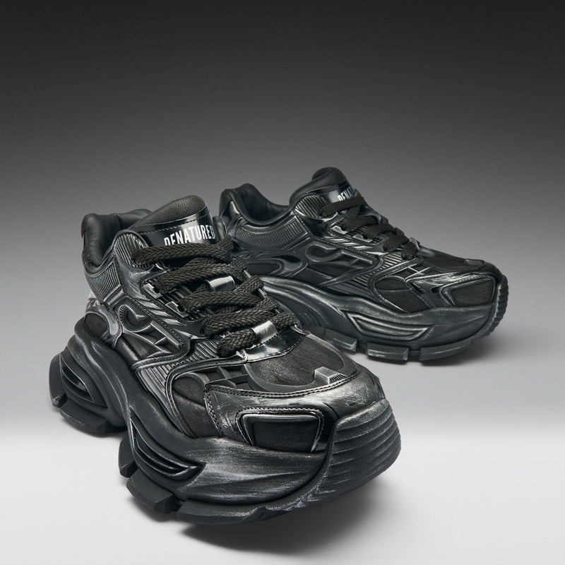 Black sneakers with unique design on a gradient background