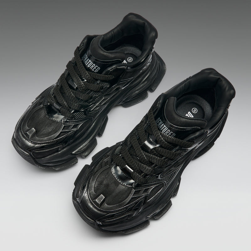 Pair of black sneakers on a gray background