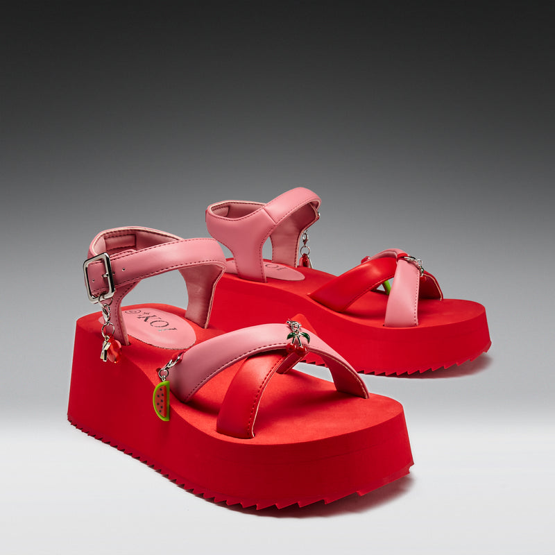 Pink sandals with red platforms on a gray background