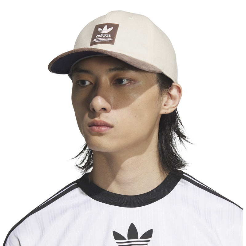 adidas Originals Terrace snapback cap in white with brown brim, worn with adidas logo