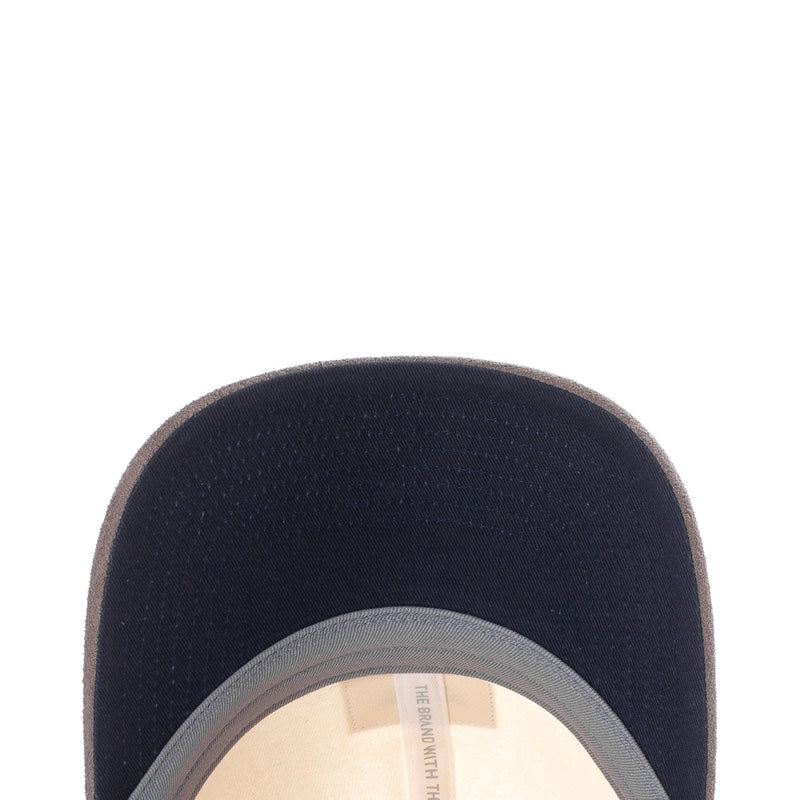 Dark navy snapback cap close-up with curved brim and light gray inner band