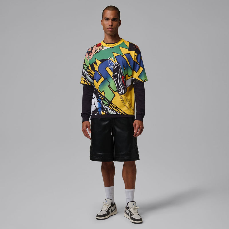 Men's multicolor graphic crewneck T-shirt with short sleeves, worn with black shorts