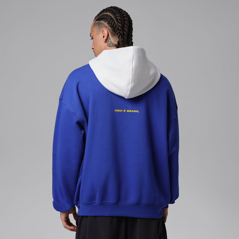 Back view: royal blue pullover hoodie with white hood lining and small Brasil text