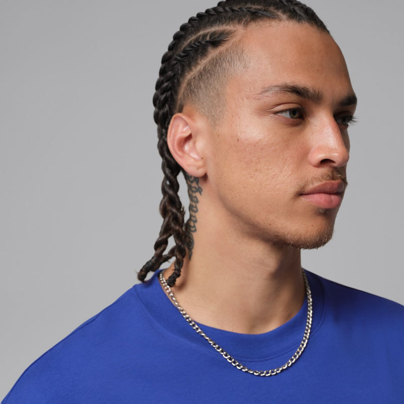 Men's blue crew-neck T-shirt neckline close-up with chain detail