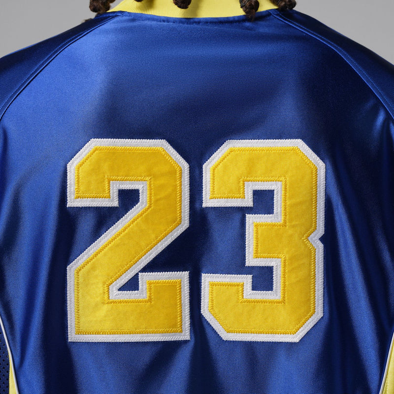 Back number 23 patch on royal blue goalie jersey with yellow outline.