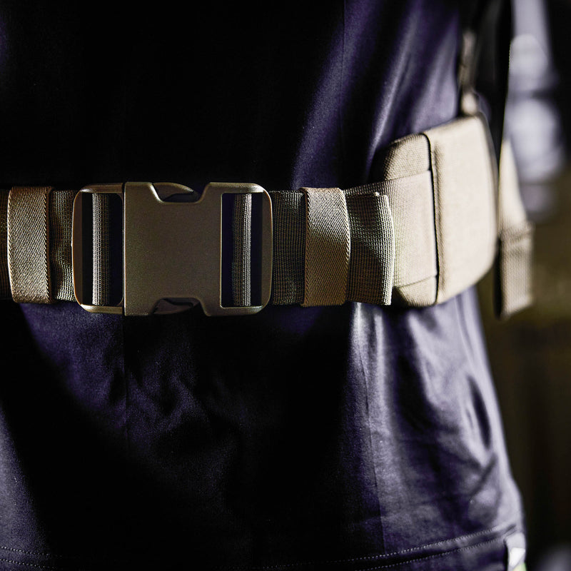 Close-up of a person wearing the Padded Hip Belt in tan with a large buckle over a dark shirt—designed for comfort and support during rucking.