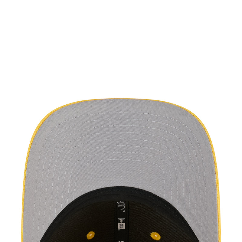 Baseball cap interior close-up with ventilation holes and black front panel edge