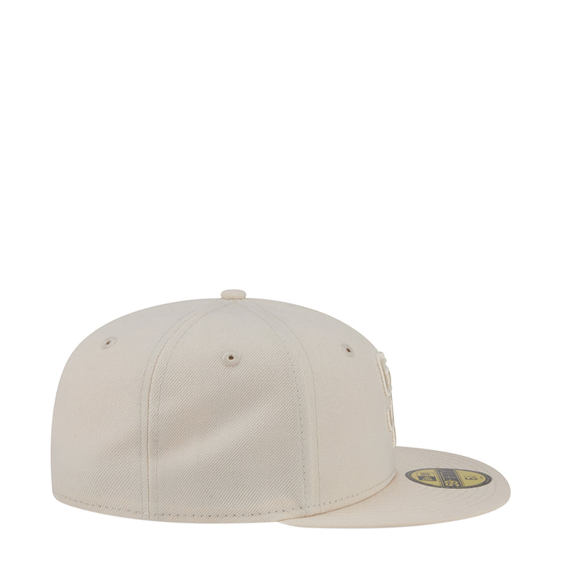 Light cream baseball cap side view with small eyelets and tonal logo