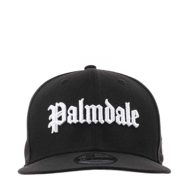 Black baseball cap with white script logo on the front and flat brim