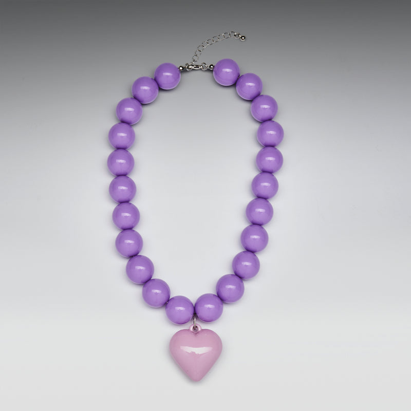 Purple beaded necklace with a heart-shaped pendant on a gray background