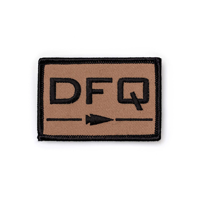 GORUCK DFQ patch in tan with black lettering and arrow, durable rucking gear accessory