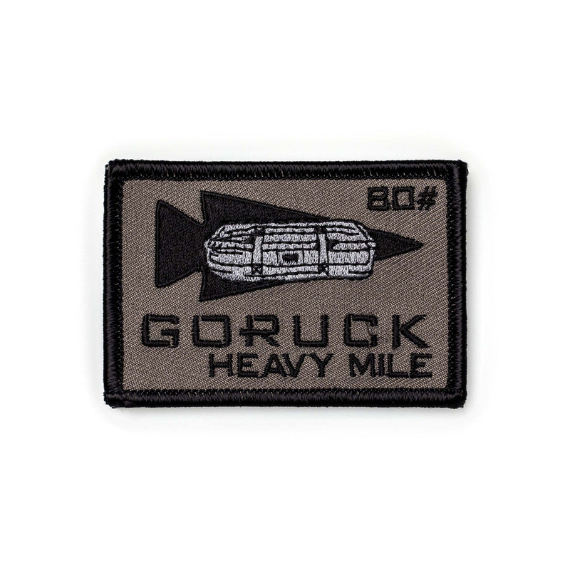 Rectangular Patch - HEAVY MILE with rucksack and arrow design, labeled "GORUCK HEAVY MILE 80" in black—ideal for marking your Heavy Mile weight carry achievement.