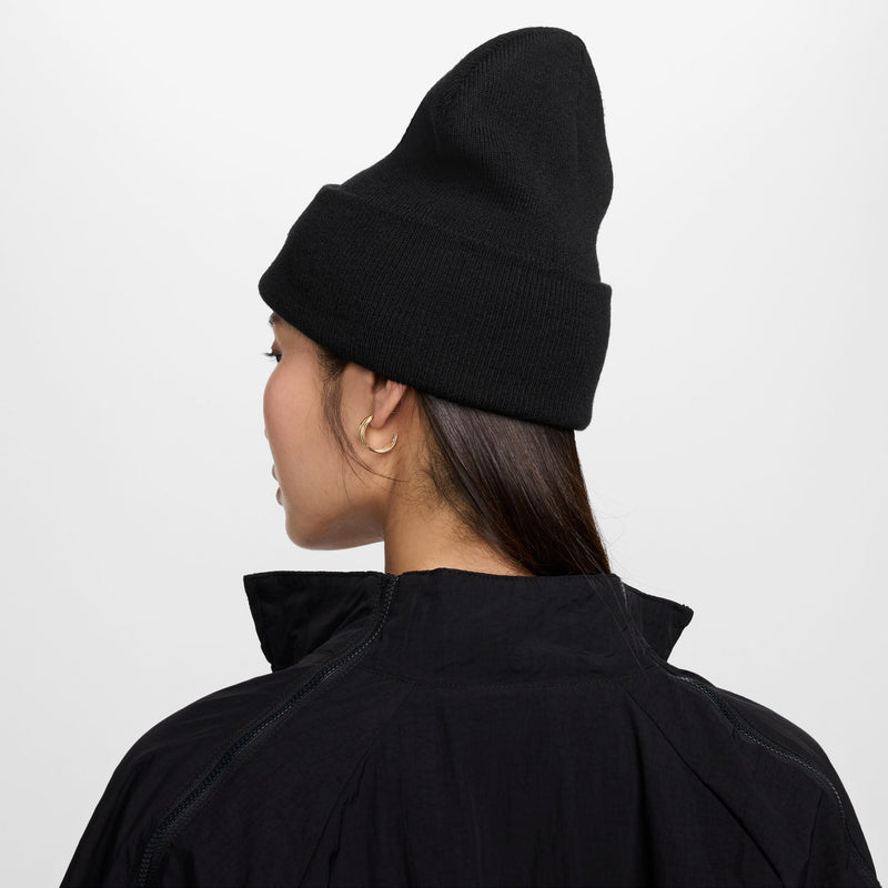 Black Nike beanie worn from the back, folded cuff with small logo detail.