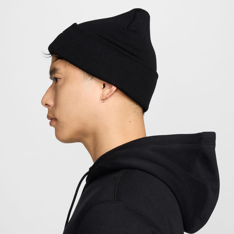 Black tall cuff beanie with white Nike swoosh logo, side view