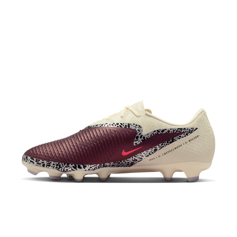 Men's soccer cleat angled side view: cream upper, burgundy wrap, red swoosh
