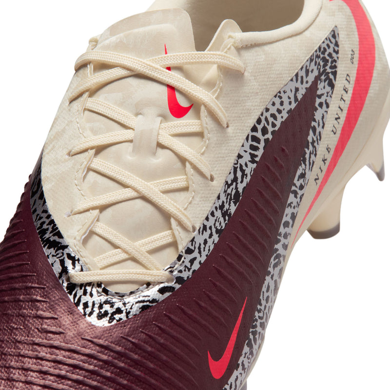 Men's soccer cleat close-up: cream laces, burgundy ribbed texture, red swoosh