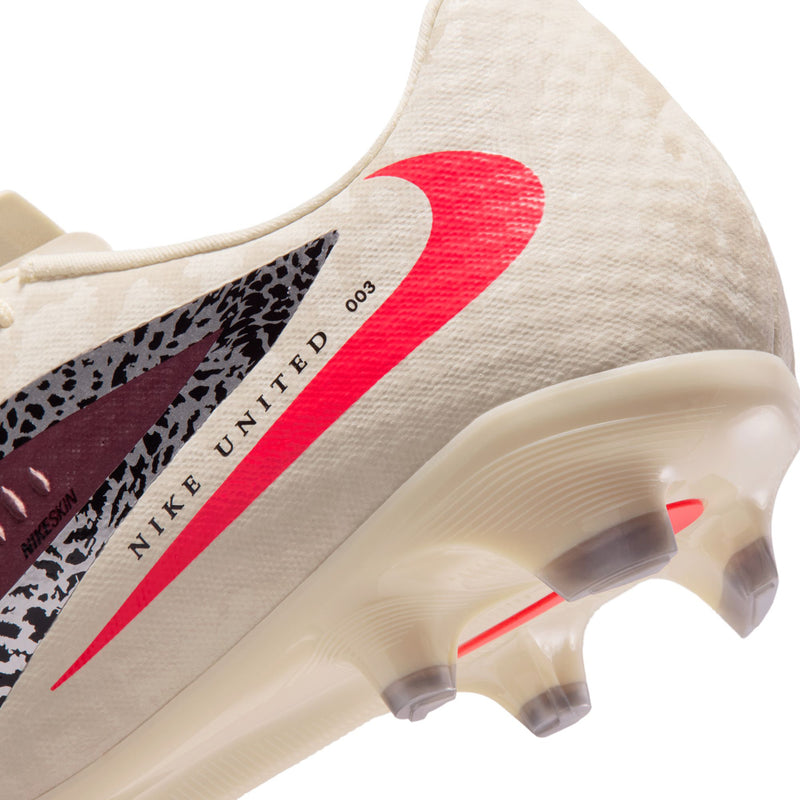 Men's soccer cleat close-up of upper and outsole with red swoosh and stud details