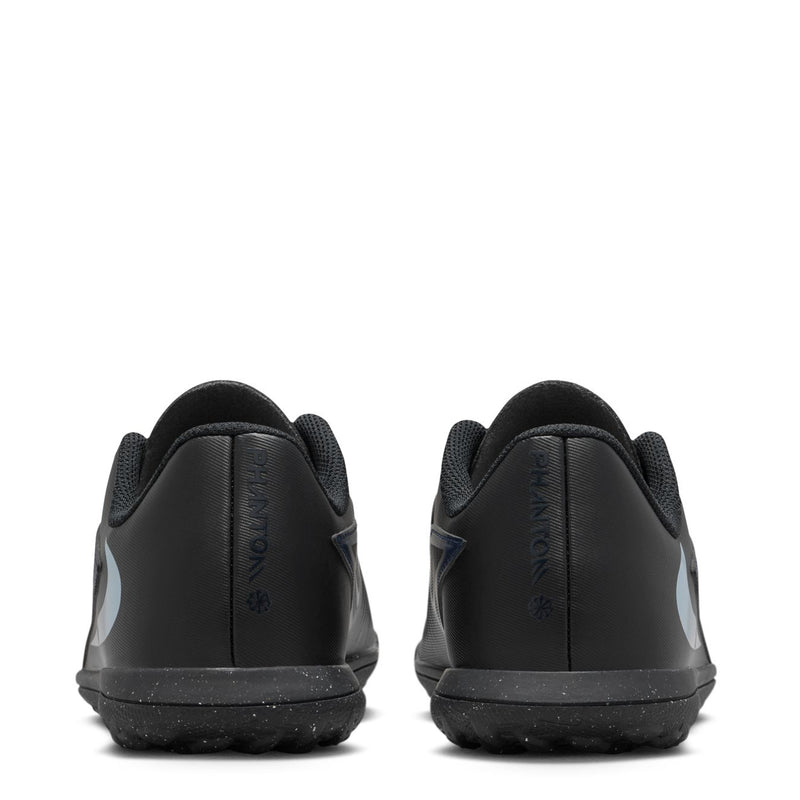 Youth low-top soccer turf shoes back view, black heel with blue logo accents