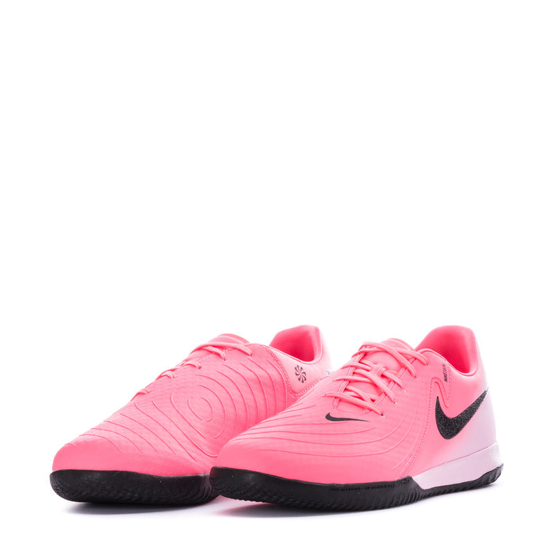 Pair of pink soccer cleats with black Swoosh, lace-up uppers, and black soles