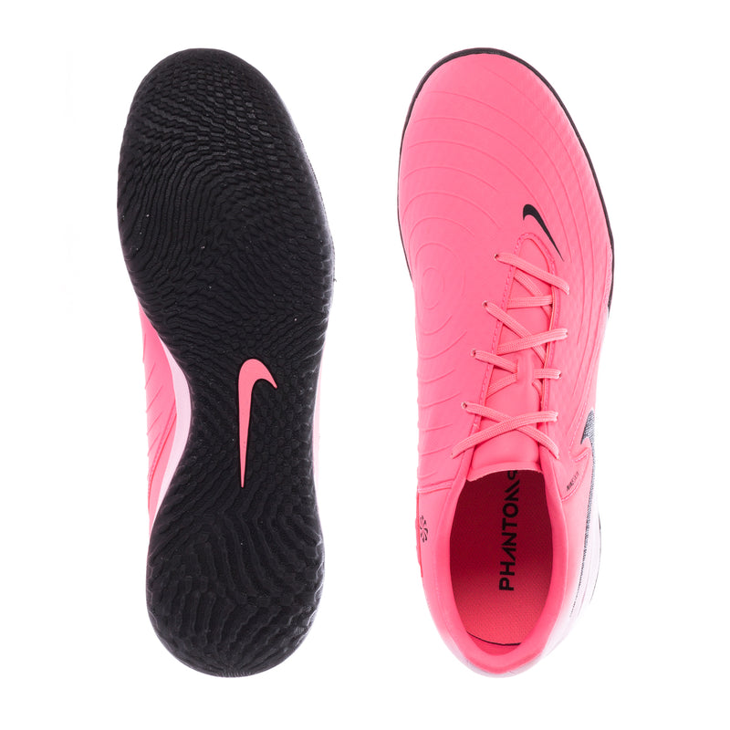 Pink soccer shoe outsole view with black tread and side Swoosh logo