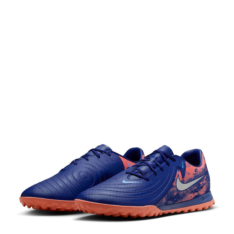 Men's dark blue turf soccer shoes, angled front view with orange outsole