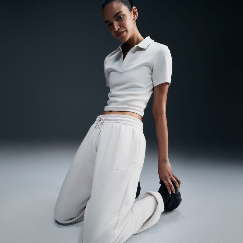 Women’s off-white sweatpants, front view: drawstring waist, side pocket, relaxed tapered fit