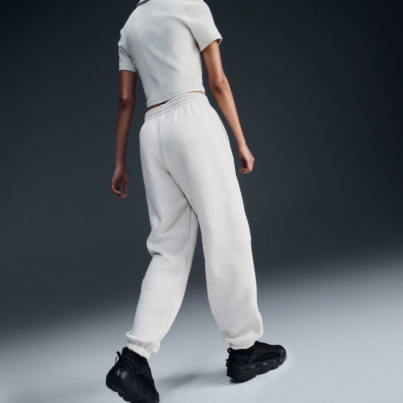 Women’s off-white jogger pants, side view: elastic waistband, drawstring, cuffed hem, side pockets