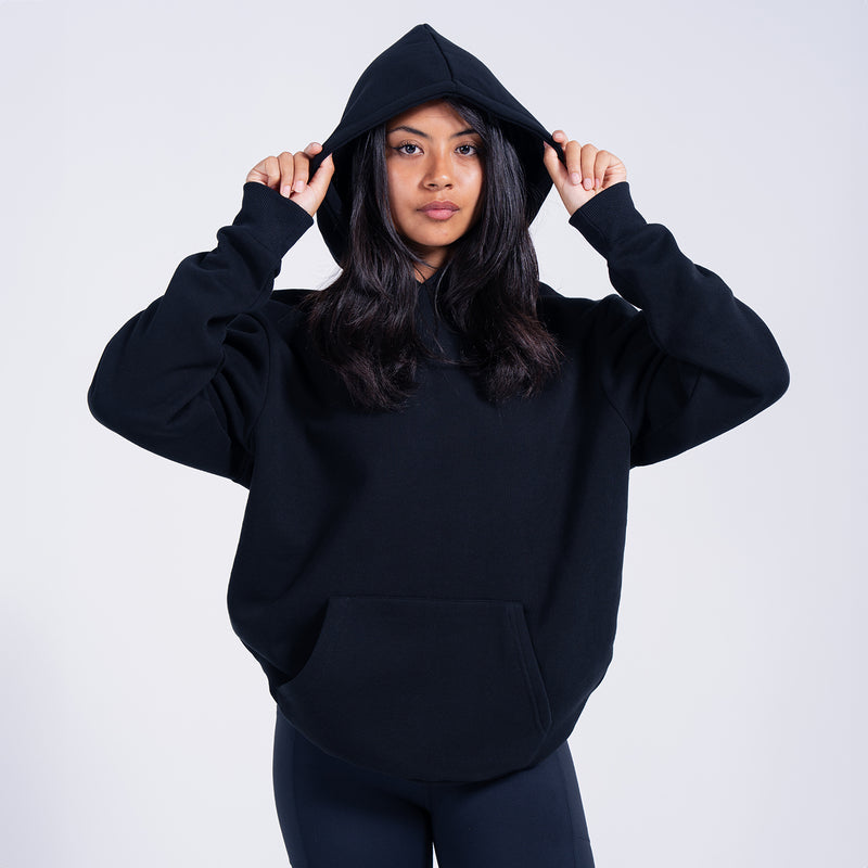 Women's black fleece pullover hoodie with hood up and kangaroo pocket