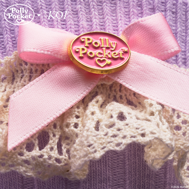 Pink bow with 'Polly Pocket' badge on a textured background
