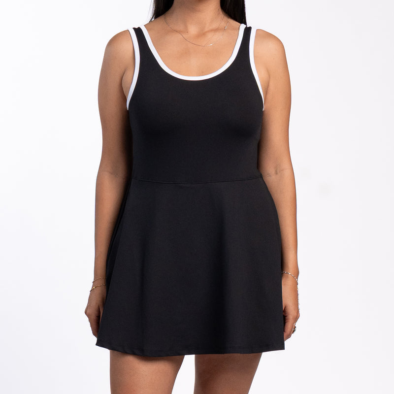Black sleeveless skater dress with white-trim neckline and waist seam