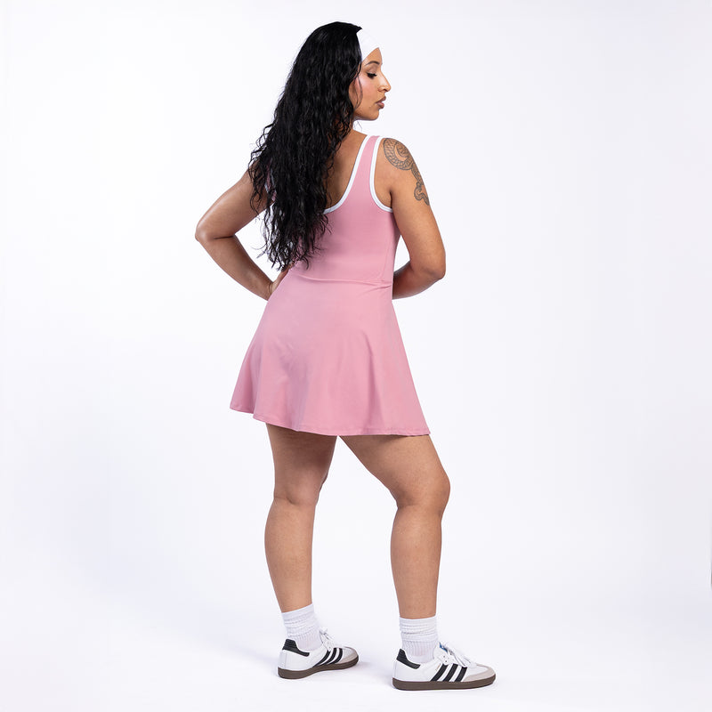 Rose pink sleeveless mini dress, white-trim scoop neckline, flared hem from back view