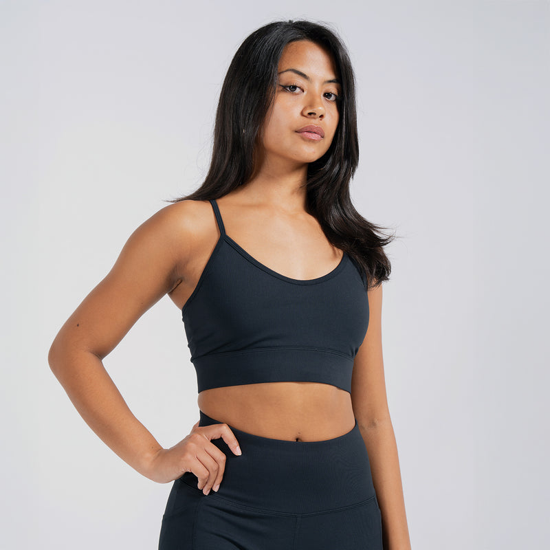 Women's black sports bra with smooth fabric and fitted shoulder straps