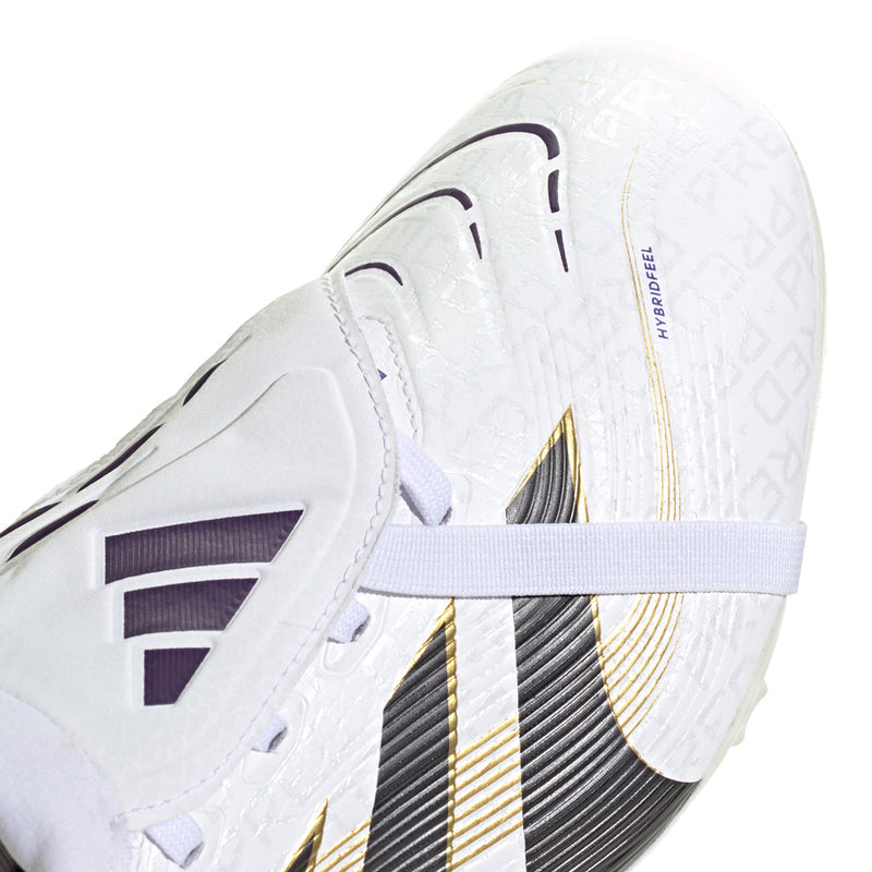 Close-up of white soccer cleat upper with black stripe panel and gold trim