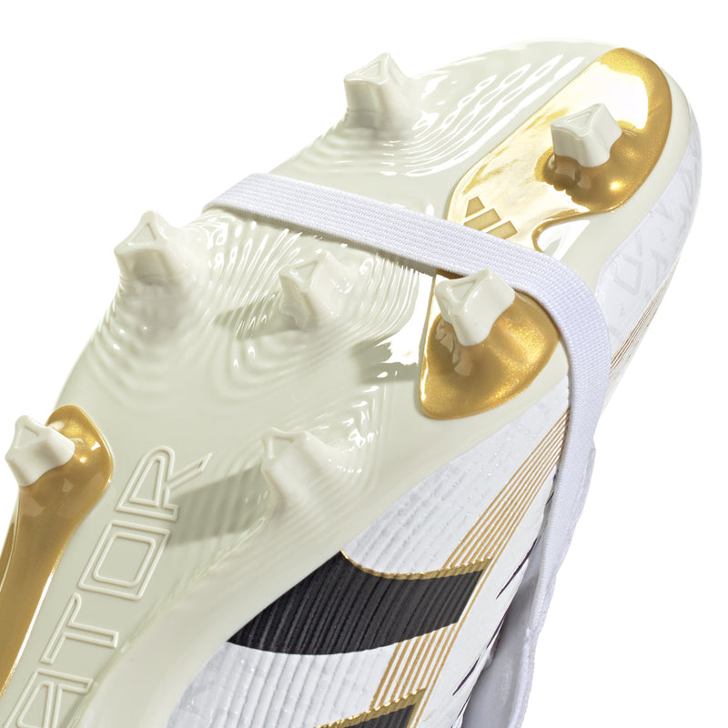 Bottom view of white soccer cleat with gold studs and gold logo detail