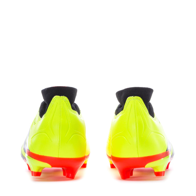 Back view pair of neon yellow soccer cleats with red heel trim and black collars