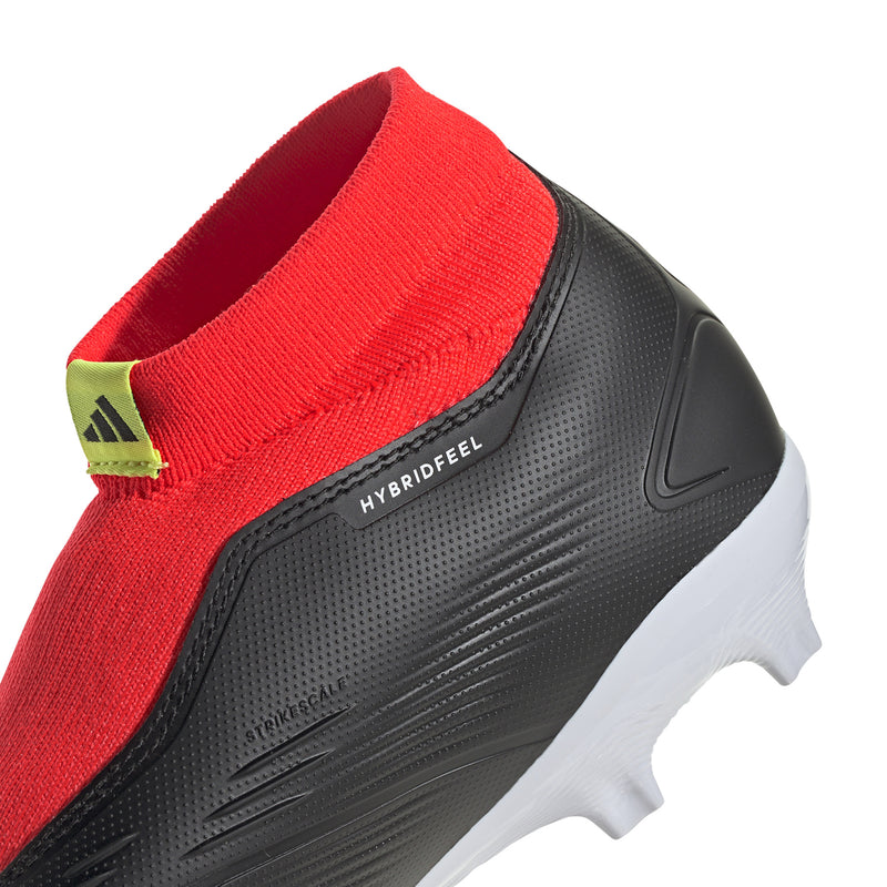 Black firm-ground soccer boot with red elastic collar, HYBRIDFEEL branding, and white studs